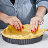 Roll the pastry out to 2-3mm thick before lining the tin.