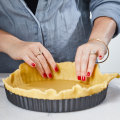 Roll the pastry out to 2-3mm thick before lining the tin.