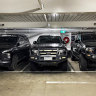Three large utes pack into spaces in a city carpark on Thursday.