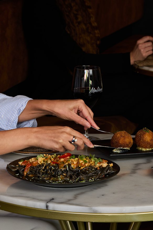 Squid ink spaghetti with crab meat, cherry tomato confit, lime &amp; chilli.