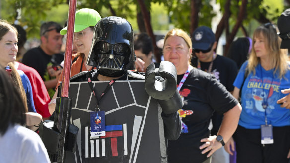 Andrea Feale is dressed as Lego Darth Vader outside the D23 convention.