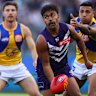 PERTH, AUSTRALIA - JULY 26: Isaiah Dudley of the Dockers looks to handball during the round 20 AFL match between the Fremantle Dockers and West Coast Eagles at Optus Stadium on July 26, 2025 in Perth, Australia. (Photo by Paul Kane/Getty Images)