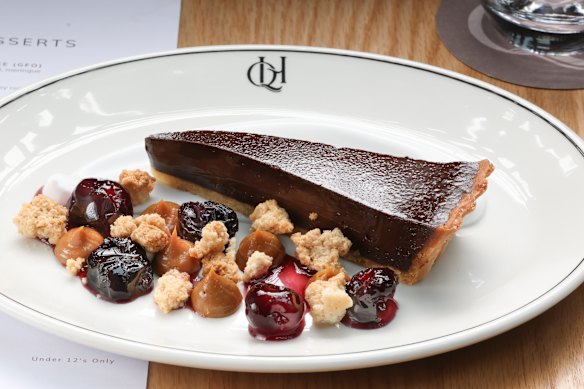 Chocolate tart with macerated cherries and dulce de leche.
