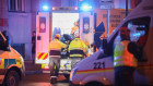 Paramedics load a stretcher into an ambulance van at the location of the shooting