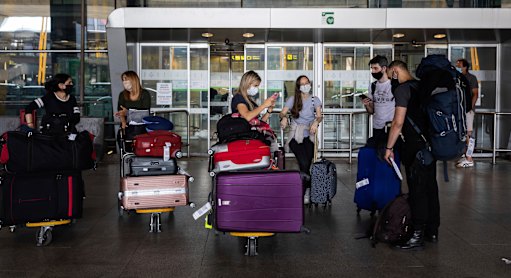 Passengers arrive at Adolfo Suarez Madrid-Barajas airport in Spain on Sunday.