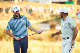 Marc Leishman and Jason Day celebrate their birdie on the 18th green.