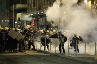 Police fire tear gas at protesters in Hong Kong on Sunday night.