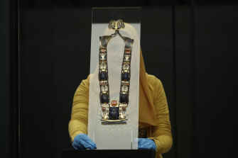 Restorer Olfat Mohamed with an artefact that is part of the Tutankhamun: Treasures of the Golden Pharaoh exhibition at the Saatchi Gallery in London.