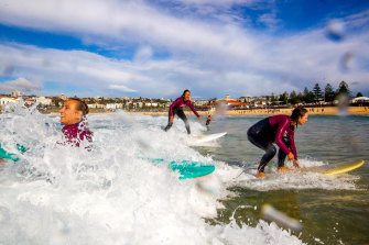 Surf riders Mona La Cour, Diana Oliva-Cave and Joanna Hill are part of the Surfie Chicks surf group for older women.