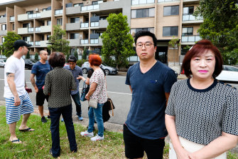 Robin Son, left, Mihi Chung and other owners of the Lidcombe apartment building.
