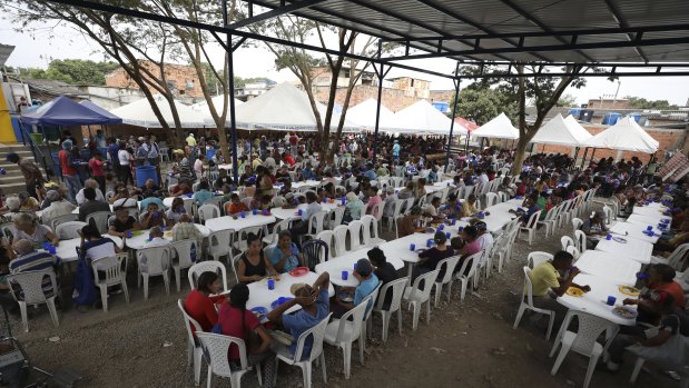 Venezuelan migrants eat at a migrant shelter near Cucuta, Colombia, on the border with Venezuela last year. The shelter serves about 4500 free lunches daily.