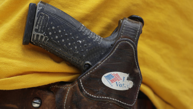 A man wears an unloaded pistol during a pro gun-rights rally in Austin, Texas.