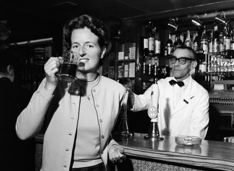 Daily Mirror photographer Doreen Spooner drinking beer for a feature in the Daily Mirror, 1962.