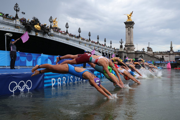 Competitors start the swimming leg of the women’s individual triathlon.