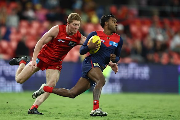 Kysaiah Pickett of the Demons shows plenty of dash, finding space ahead of Matt Rowell.