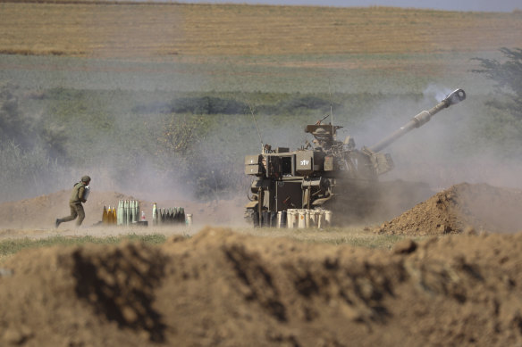 An Israeli artillery unit fires toward targets in Gaza Strip from the Israeli border on Saturday.