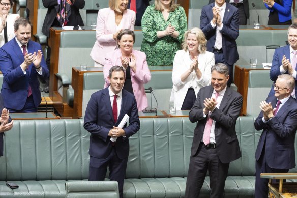 Treasurer Dr Jim Chalmers is congratulated by colleagues after delivering the Budget speech.