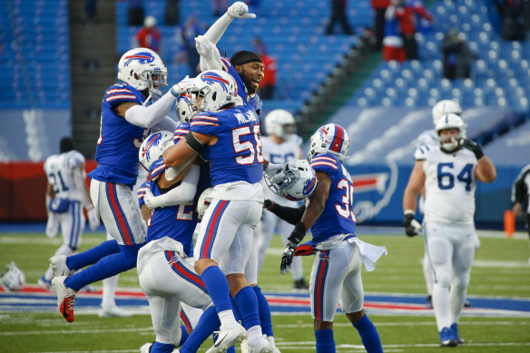 Matt Milano (No.58) celebrates with Bills teammates after their drought-breaking win.