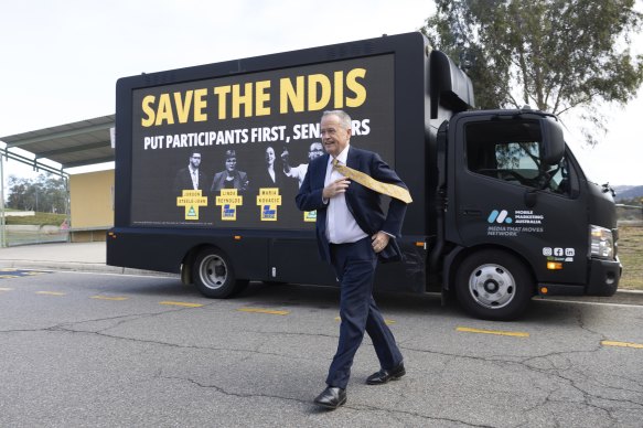 Bill Shorten with the driving billboard that’s being used to campaign against the Coalition and Greens.
