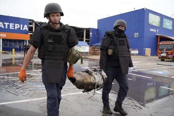 Ukraininan police officers carrying the wreckage of a Russian drone in Kharkiv last month. The strike that killed a 40-year-old man and injured five others was carried out by a Russian Geran-4 jet-powered drone equipped with a camera.