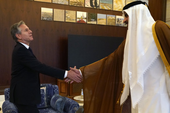 US Secretary of State Antony Blinken, left, and Qatari Emir Sheikh Tamim bin Hamad al-Thani shake hands before their meeting in Lusail, Qatar, on October 13.