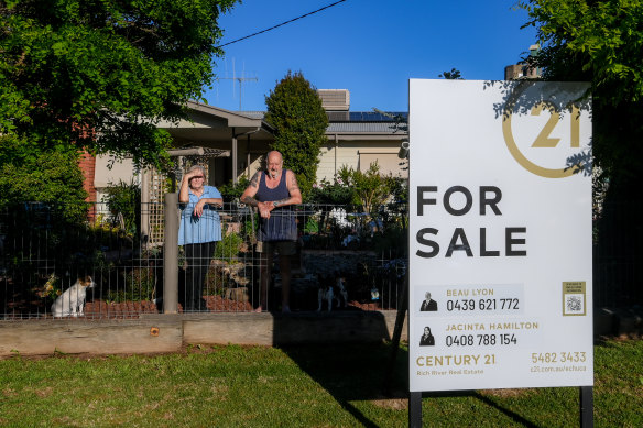 Margaret and Keith Tate in front of the house they have sold. 