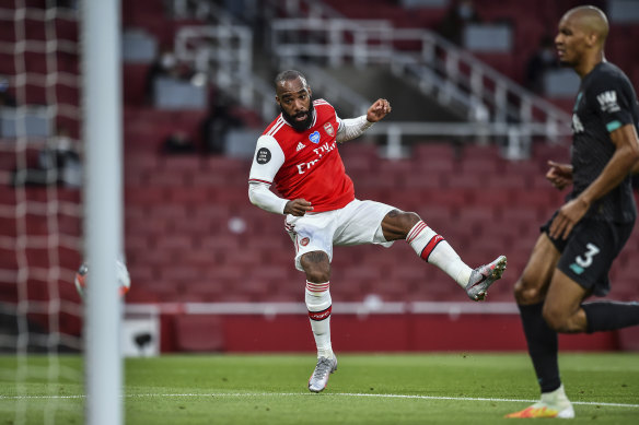 Arsenal's Alexandre Lacazette scores his team's first goal during the English Premier League soccer match between Arsenal and Liverpool at the Emirates Stadium.