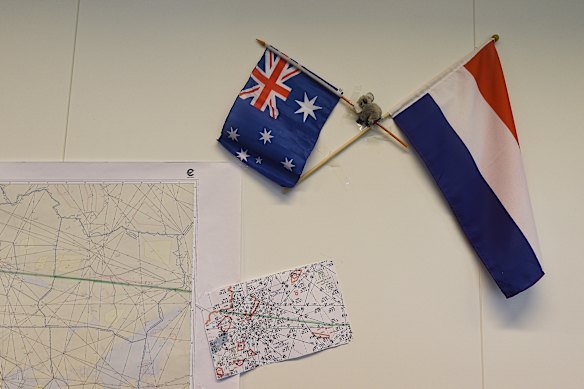 An Australian and Dutch flag hang on the wall next to maps showing the flight path of MH17 in the National Police of the Netherlands criminal investigation building in 2015.  