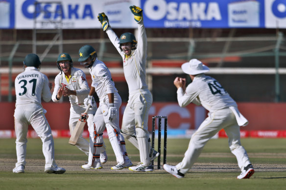 Australia’s David Warner, left, Marnus Labuschagne, second left, Alex Carey, second right, and  Steve Smith celebrate after the dismissal of Pakistan’s Faheem Ashraf.