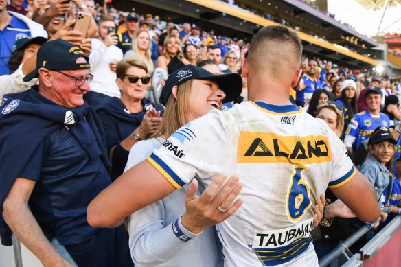 Ted Arthur (left) watches on as Michelle Arthur shares a special moment with here son Jakob after the 18-year-old scored a try on debut in Brisbane last year.