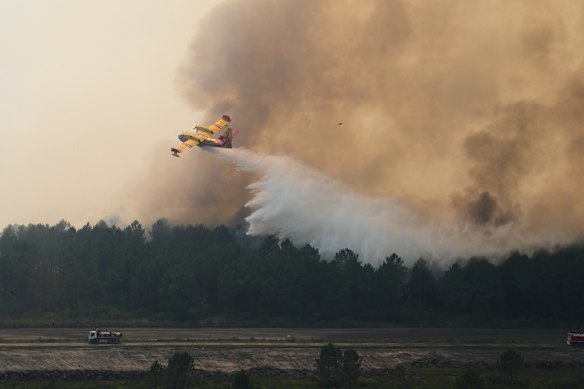 A plane prepares to dump its load of water.