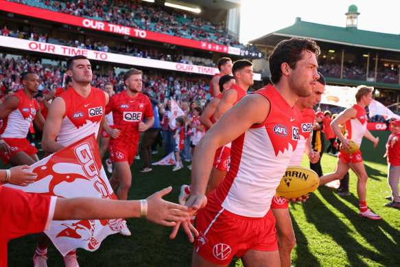 Oliver Florent of the Swans and team mates run onto the field at the SCG