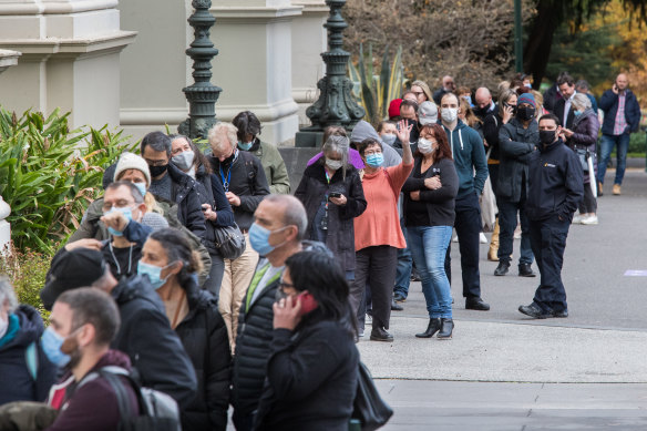 Lines of people wait to be vaccinated at the Exhibition Building in Carlton on Thursday.