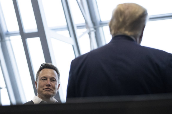Tesla billionaire Elon Musk speaks with  Donald Trump in 2020.