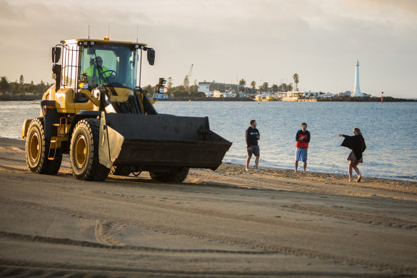 Cleaners finish up the clean-up after New Year's Eve celebrations at St Kilda beach on Wednesday morning.