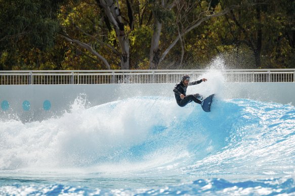 Veteran pro surfer Tom Carroll rides a wave at the new Homebush Bay facility.