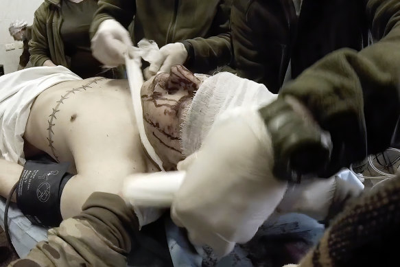 Yuliia Paievska, known as Taira, and other medical personnel bandage the head of an injured serviceman Mariupol, Ukraine.