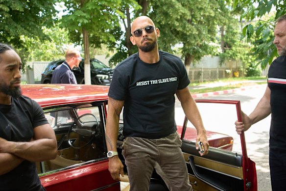 Andrew Tate arrives at a police station in a Lada vehicle in Voluntari, Romania, on Wednesday.