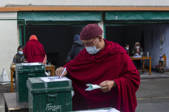 A monk casts his ballot.