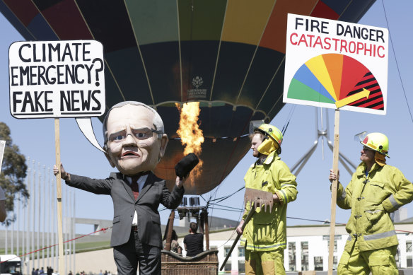 A climate change rally takes place on the front lawn of Parliament House on Tuesday as a motion to declare a climate emergency was voted down.