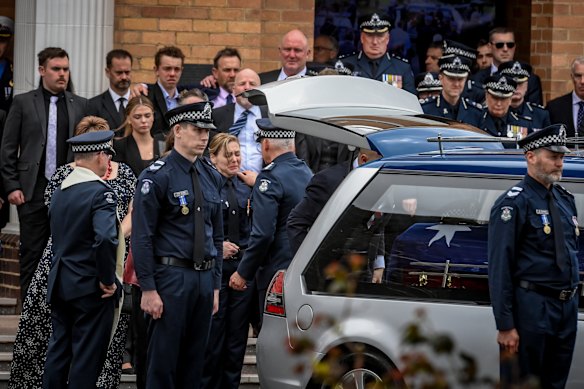 Family and friends at Neal Thompson’s funeral in September.
