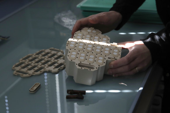 Stephanie Cluzet, head of Vine Researcher at the Institute for Wine and Vine Research, displays a container where snippets of grapevines spent a year orbiting Earth.