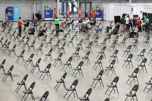 Chairs set out for people to wait after receiving a vaccine dose inside the Brisbane Convention and Exhibition Centre hub in August.