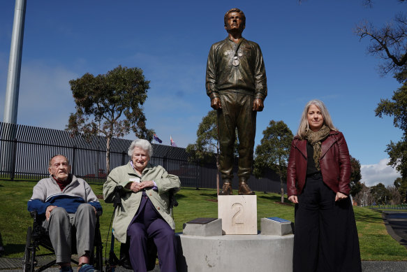 Janita Norman (right) poses with her grandmother Thelma Norman and coach Neville Sillitoe alongside the statue of Peter Norman.