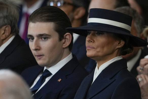 Barron Trump and first lady Melania Trump listen as President Donald Trump gives his inaugural address.