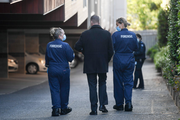 Homicide detectives and forensics officers examined the scene at the Richmond apartment on Saturday morning.