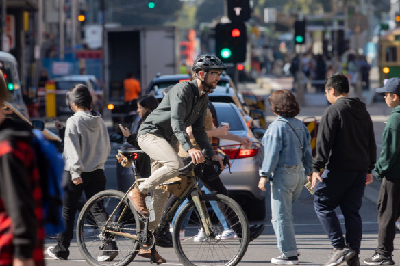 A cyclist in Flinders Street, where a planned separated bike lane is also on hold. 