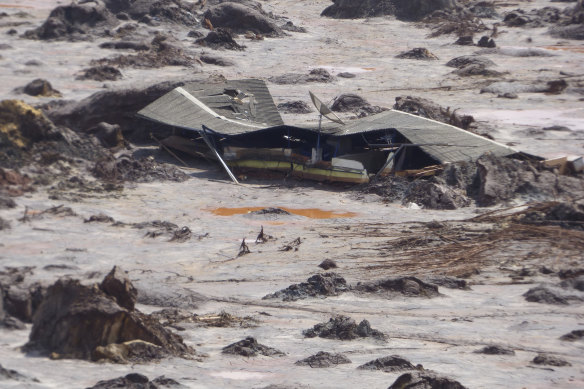 A structure is buried in mud in the Bento Rodrigues valley after BHP-Vale's Samarco dam failure in 2015.