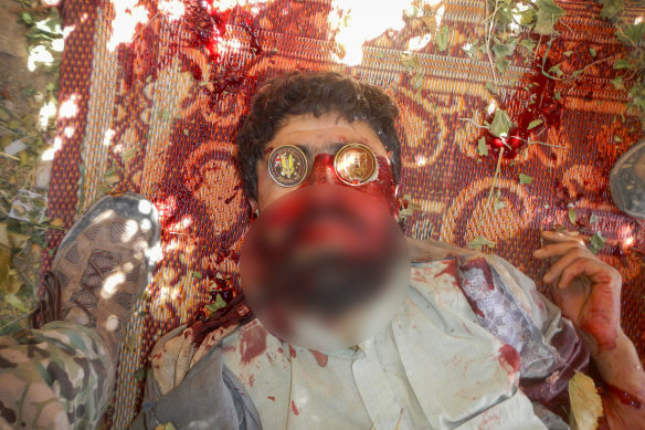 A dead suspected Taliban fighter on whose eyes were placed two souvenir Australian military coins.