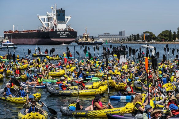 Climate protesters in kayaks attempt to block access to the Port of Newcastle.